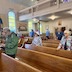 A view of parishioners standing the the pews. The photo was taken from the front, left corner of the church, which is stage-right, from the perspective of someone standing in front of the iconostas and looking towards the congregation).