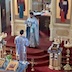 Fr. Aleksey holds the Holy Gifts as he stands in front of the Royal Doors. There's an altar server standing at the bottom of the three steps, and he's facing Fr. Aleksey. Both are wearing light blue vestments that match the cloths covering the Holy Gifts.