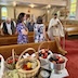 The photo's perspective is from the right-front corner of the church, looking back on the pews. Fr. Aleksey is walking up the center aisle, towards the altar and left side of the frame. Parishoners are standing in the pews, and the table with fruit fills the bottom third of the frame. There's also a prayer book on the table with the fruit.